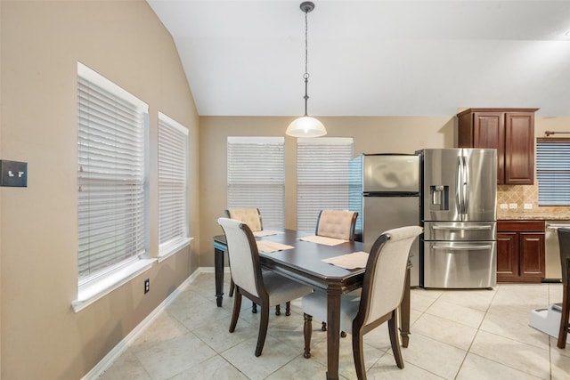 15015 Cozy Hollow Ln, Houston, TX 77044 - dining area with lofted ceiling, light tile patterned floors, and baseboards