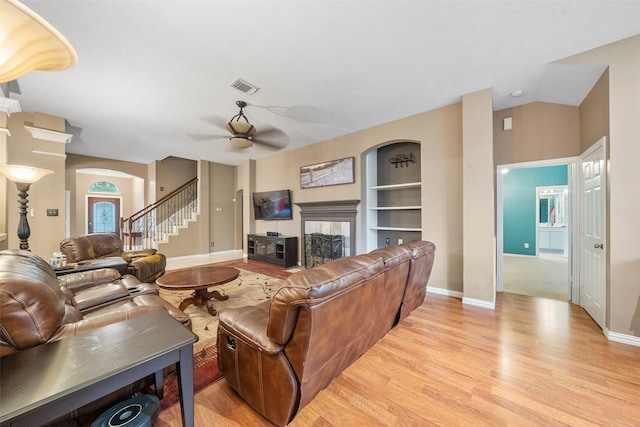 15015 Cozy Hollow Ln, Houston, TX 77044 - living area with a fireplace, a ceiling fan, light wood-style flooring, stairs, and baseboards
