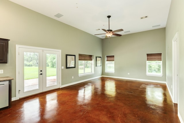 interior space featuring a healthy amount of sunlight, concrete floors, visible vents, french doors, and high vaulted ceiling