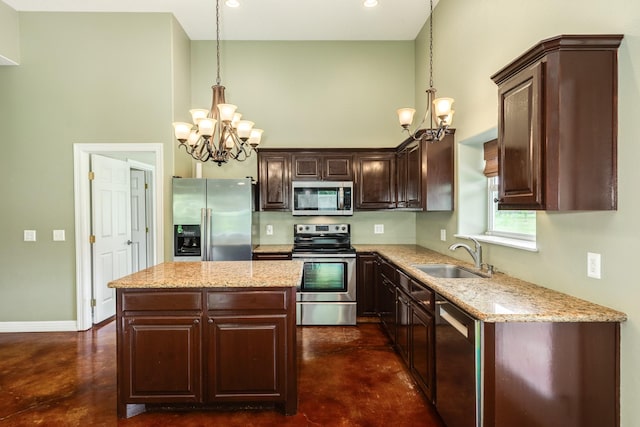 kitchen featuring finished concrete flooring, stainless steel appliances, a notable chandelier, and a sink