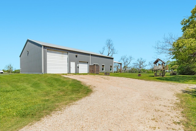 view of outdoor structure featuring driveway and an outbuilding
