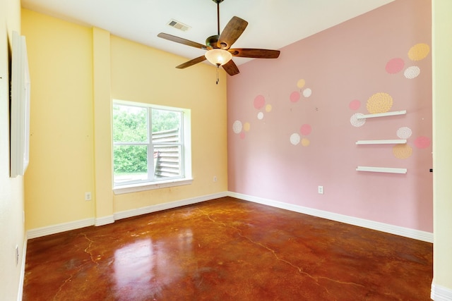 unfurnished room featuring finished concrete flooring, visible vents, a ceiling fan, and baseboards