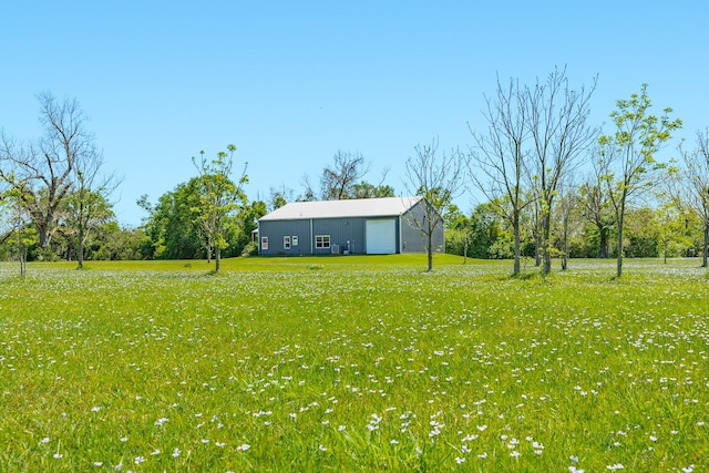 view of yard featuring an outdoor structure, an outbuilding, and a garage