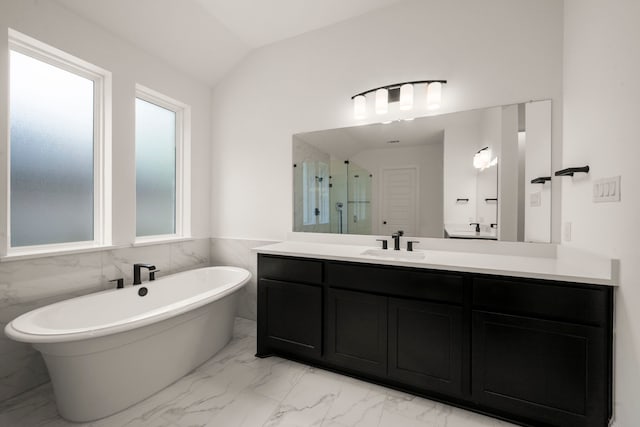 1222 Tallow Park Ln, Pinehurst, TX 77362 - bathroom with marble finish floors, a freestanding tub, vanity, a stall shower, and vaulted ceiling