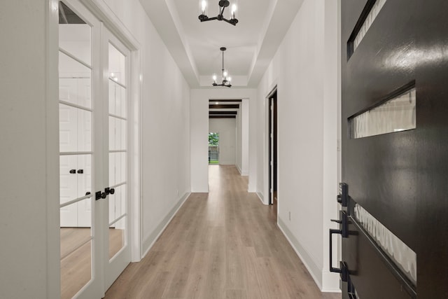 1222 Tallow Park Ln, Pinehurst, TX 77362 - hallway with a chandelier, light wood finished floors, french doors, and baseboards