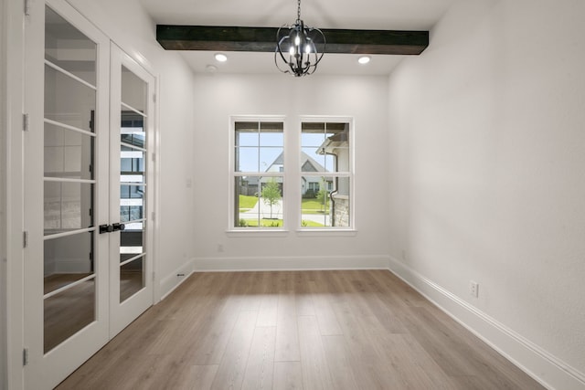 1222 Tallow Park Ln, Pinehurst, TX 77362 - unfurnished dining area with a chandelier, beamed ceiling, french doors, light wood finished floors, and baseboards