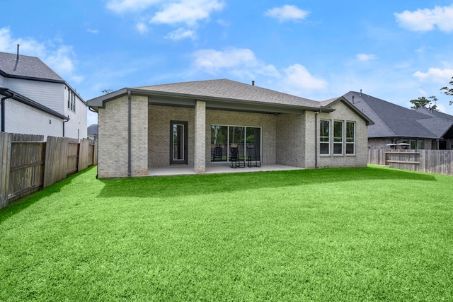 1222 Tallow Park Ln, Pinehurst, TX 77362 - back of property with a patio area, brick siding, and roof with shingles