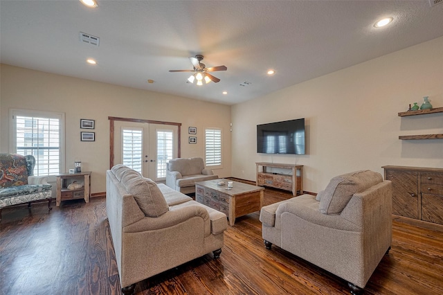 living room featuring dark wood-type flooring, french doors, a ceiling fan, and visible vents