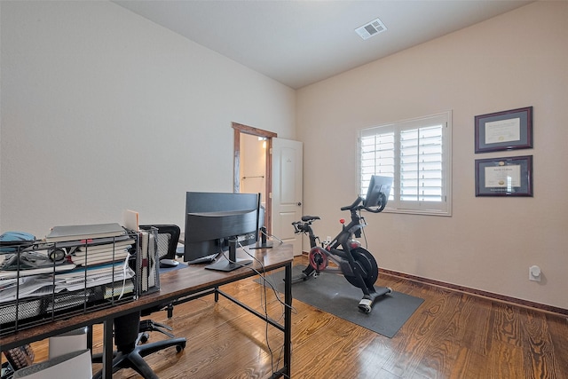 home office featuring baseboards, visible vents, and wood finished floors