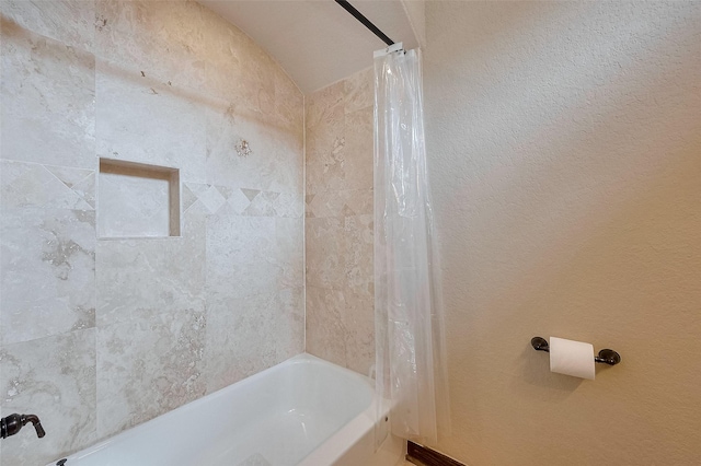 bathroom with shower / bath combo with shower curtain