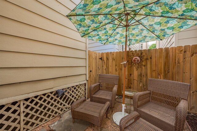 view of patio / terrace featuring fence