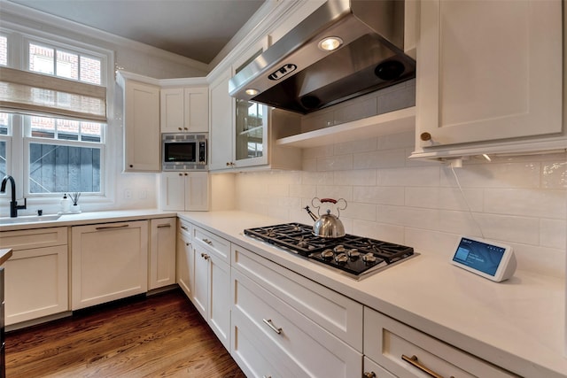4020 Sul Ross St, Houston, TX 77027 - kitchen featuring gas cooktop, stainless steel microwave, exhaust hood, and light countertops