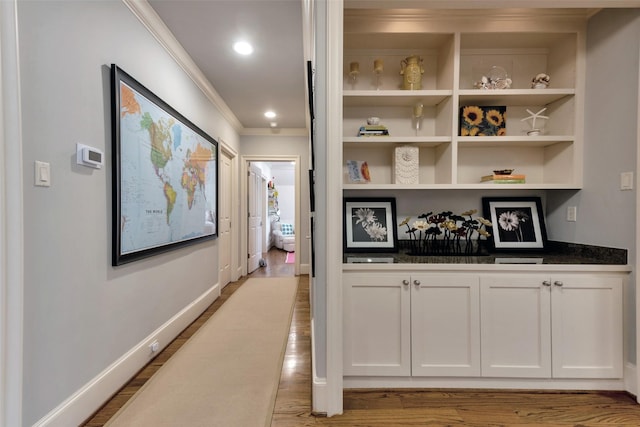 4020 Sul Ross St, Houston, TX 77027 - hallway featuring recessed lighting, built in shelves, baseboards, ornamental molding, and wood finished floors
