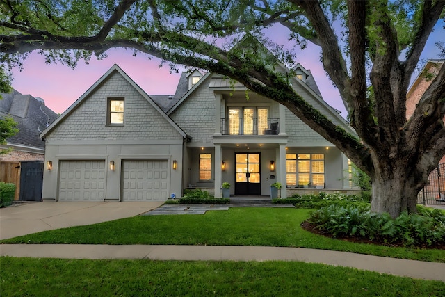 4020 Sul Ross St, Houston, TX 77027 - view of front facade featuring driveway, a front yard, stucco siding, and a garage