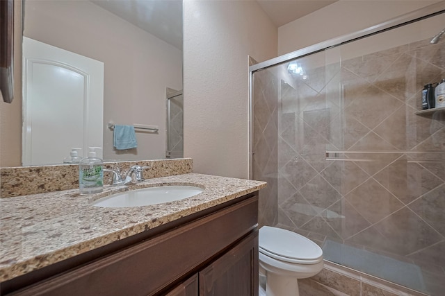 full bath with a stall shower, toilet, a textured wall, and vanity