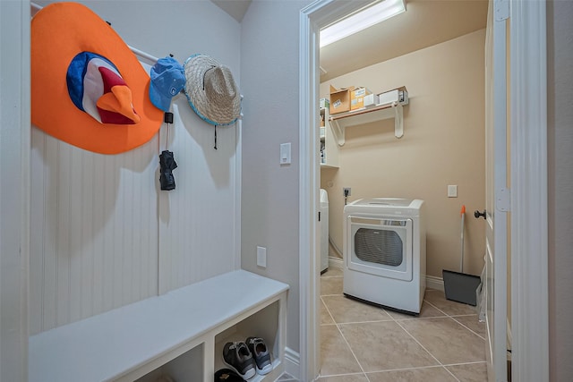 laundry room featuring washer / dryer, light tile patterned flooring, and laundry area