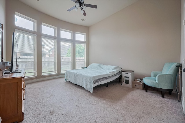 bedroom with visible vents, ceiling fan, carpet flooring, and vaulted ceiling
