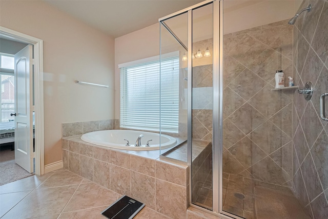 ensuite bathroom featuring a healthy amount of sunlight, a bath, and a stall shower