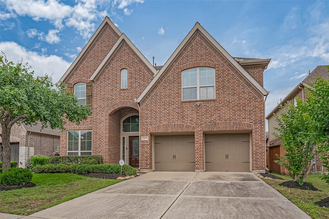 traditional-style home with a garage, brick siding, and driveway