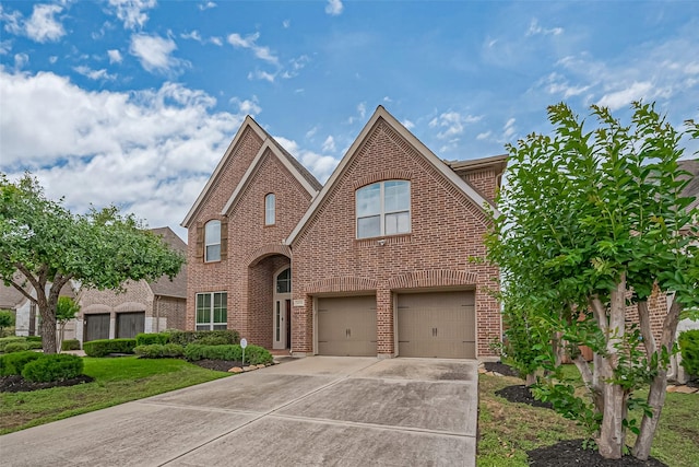 traditional-style home featuring brick siding, concrete driveway, and an attached garage