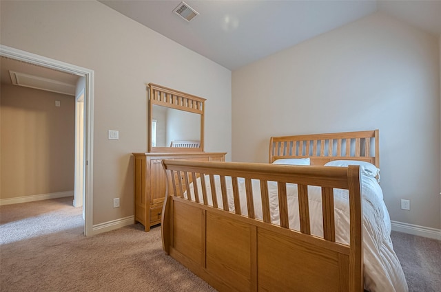 bedroom with visible vents, vaulted ceiling, light colored carpet, and baseboards
