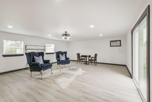living area with recessed lighting, light wood-style flooring, and baseboards