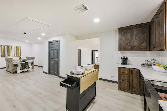 kitchen featuring visible vents, light countertops, light wood-style flooring, and dark brown cabinetry