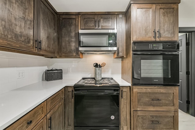 kitchen featuring dark brown cabinetry, black appliances, backsplash, and light countertops