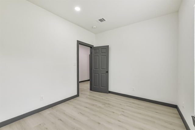 unfurnished room with visible vents, recessed lighting, light wood-style flooring, and baseboards