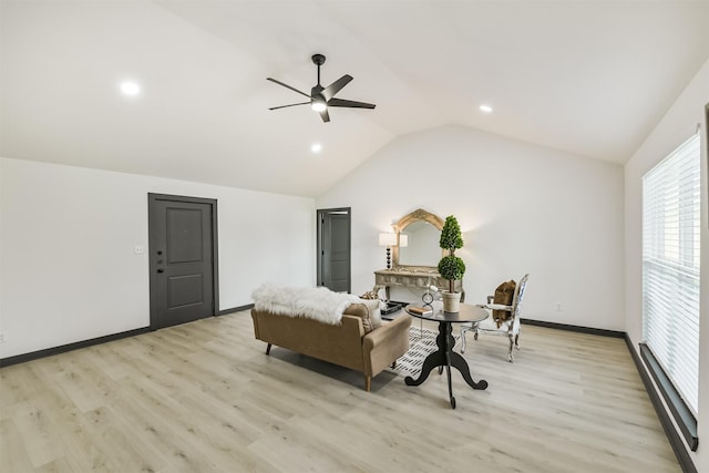 living room with light wood-style flooring, a ceiling fan, lofted ceiling, and a baseboard radiator