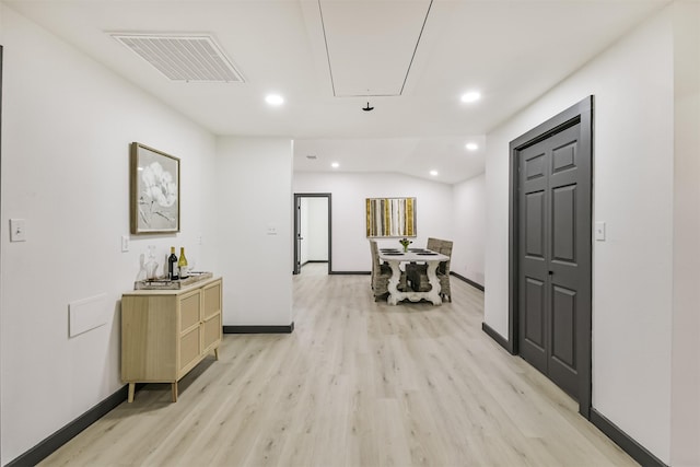 hallway with attic access, recessed lighting, visible vents, and light wood-type flooring