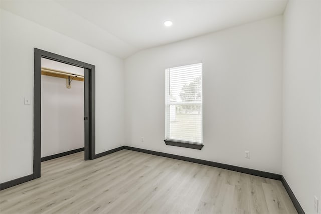 unfurnished bedroom with baseboards, recessed lighting, and light wood-style floors