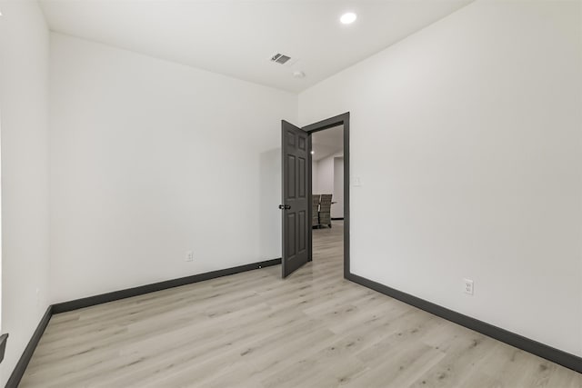 unfurnished room with visible vents, baseboards, recessed lighting, and light wood-style floors
