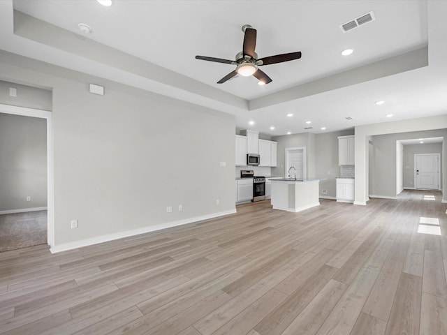 21703 White Bellflower Ln, Cypress, TX 77433 - unfurnished living room featuring ceiling fan, light wood-style floors, and recessed lighting