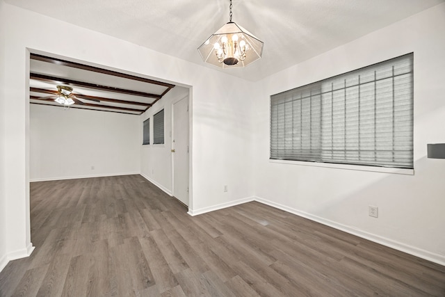 unfurnished room featuring ceiling fan with notable chandelier, beam ceiling, wood finished floors, and baseboards