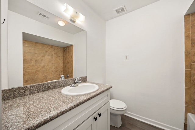 full bathroom featuring toilet, visible vents, walk in shower, and wood finished floors
