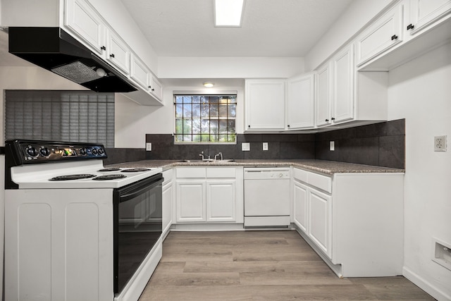 kitchen with under cabinet range hood, white cabinets, range with electric stovetop, and dishwasher