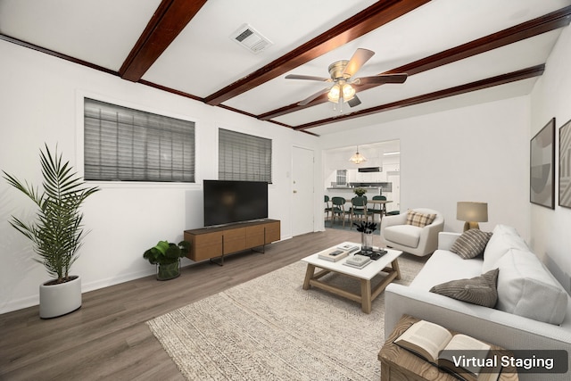 living room featuring beamed ceiling, a ceiling fan, visible vents, and wood finished floors