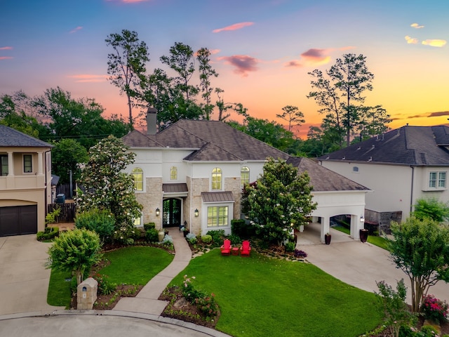 view of front facade with concrete driveway, a chimney, a front yard, and stucco siding