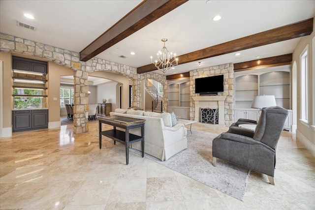living room featuring decorative columns, arched walkways, visible vents, and beam ceiling