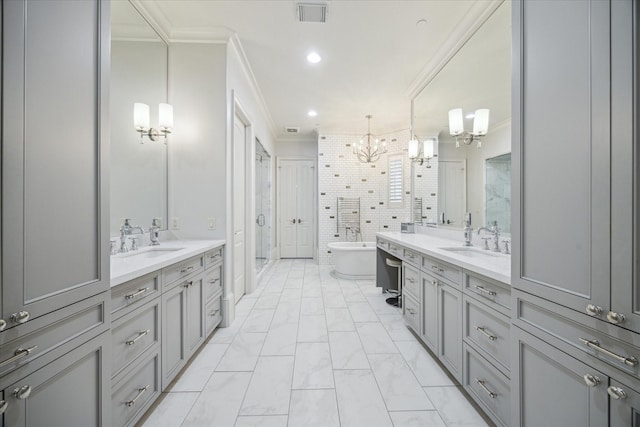 bathroom with visible vents, ornamental molding, an inviting chandelier, a sink, and a stall shower