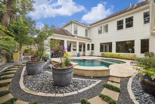 outdoor pool with fence, a patio, and an in ground hot tub
