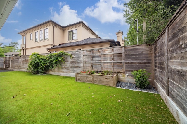 view of yard with a fenced backyard