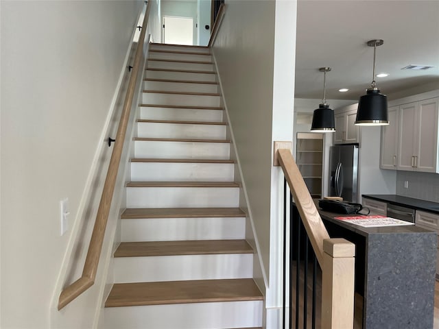stairway featuring recessed lighting and visible vents