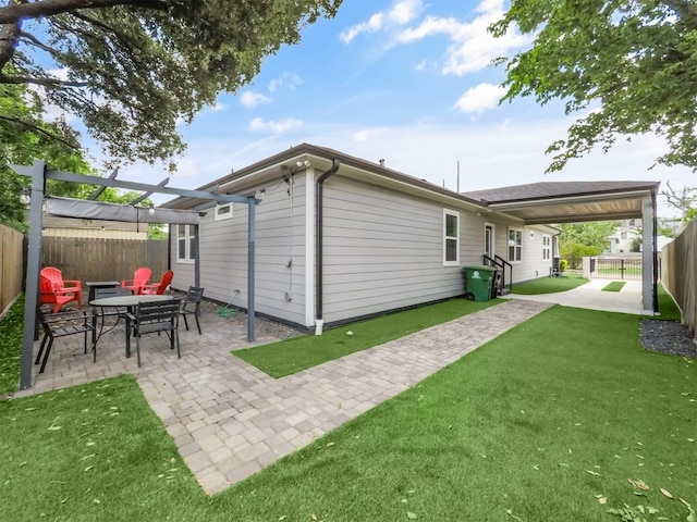 rear view of property featuring a patio, a lawn, a pergola, and a fenced backyard