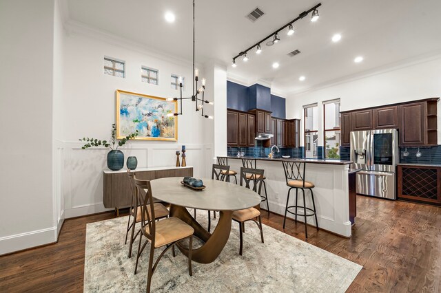 dining area featuring dark wood-style flooring, visible vents, ornamental molding, and recessed lighting