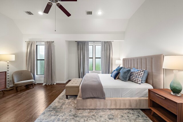 bedroom featuring visible vents, a ceiling fan, baseboards, wood finished floors, and vaulted ceiling