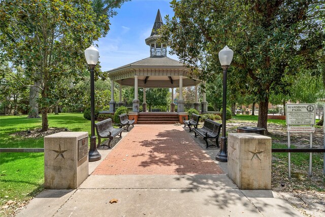 view of property's community featuring a lawn and a gazebo