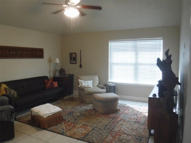 living area featuring light tile patterned floors, a ceiling fan, and plenty of natural light