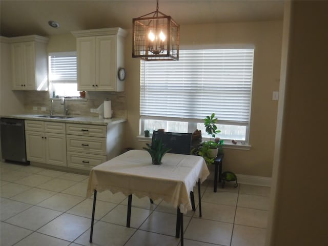 dining space featuring a chandelier, a healthy amount of sunlight, and light tile patterned flooring
